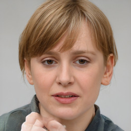 Joyful white young-adult female with medium  brown hair and blue eyes