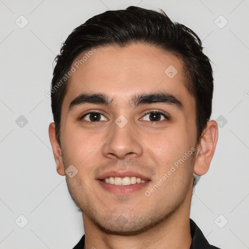 Joyful white young-adult male with short  black hair and brown eyes