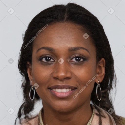 Joyful black young-adult female with long  brown hair and brown eyes