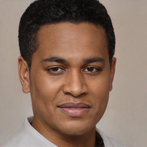 Joyful latino young-adult male with short  brown hair and brown eyes