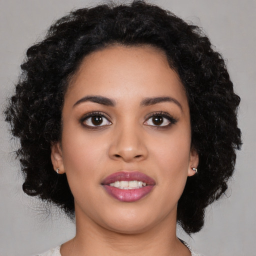 Joyful latino young-adult female with medium  black hair and brown eyes