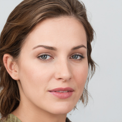 Joyful white young-adult female with medium  brown hair and blue eyes