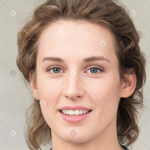 Joyful white young-adult female with medium  brown hair and green eyes