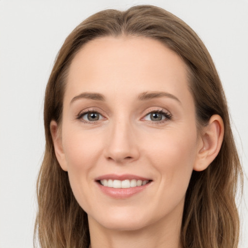 Joyful white young-adult female with long  brown hair and grey eyes