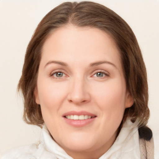 Joyful white young-adult female with medium  brown hair and green eyes