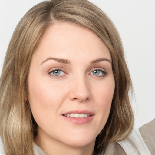 Joyful white young-adult female with medium  brown hair and blue eyes