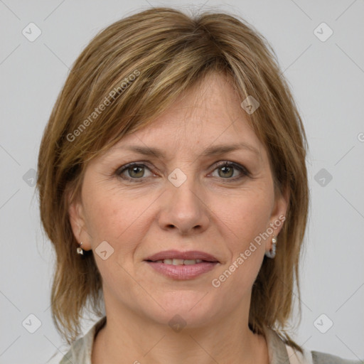 Joyful white adult female with medium  brown hair and grey eyes