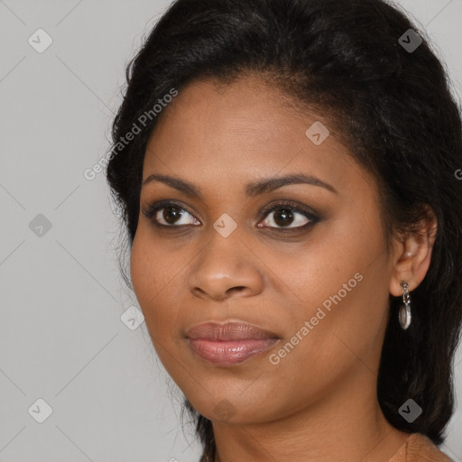 Joyful black young-adult female with long  brown hair and brown eyes