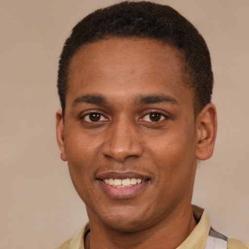 Joyful black young-adult male with short  black hair and brown eyes