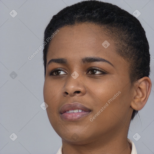 Joyful black young-adult female with short  black hair and brown eyes