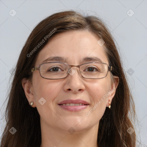 Joyful white adult female with long  brown hair and grey eyes