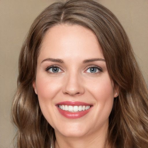 Joyful white young-adult female with long  brown hair and green eyes