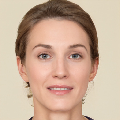 Joyful white young-adult female with medium  brown hair and grey eyes