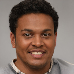 Joyful latino young-adult male with short  brown hair and brown eyes