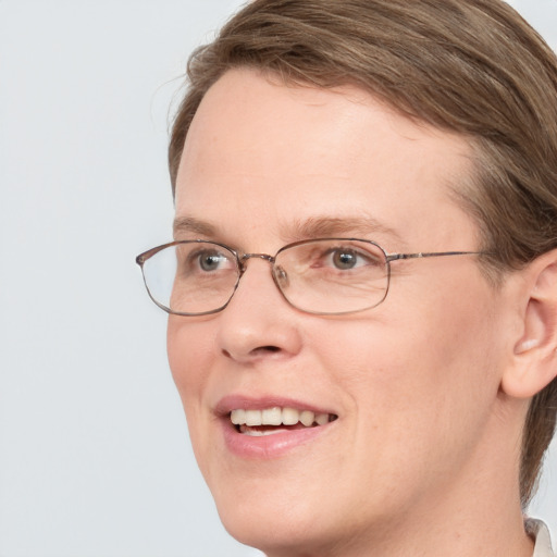 Joyful white adult female with medium  brown hair and blue eyes