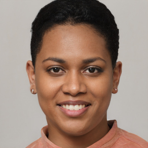Joyful black young-adult female with short  black hair and brown eyes