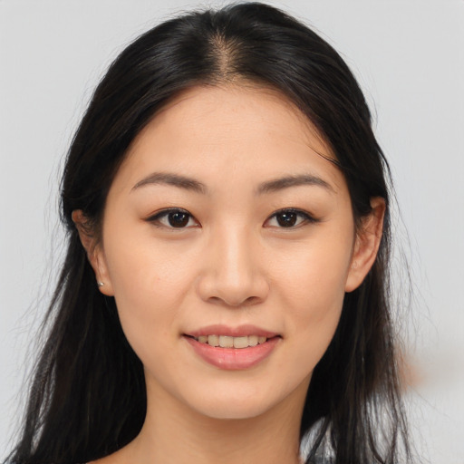 Joyful asian young-adult female with long  brown hair and brown eyes