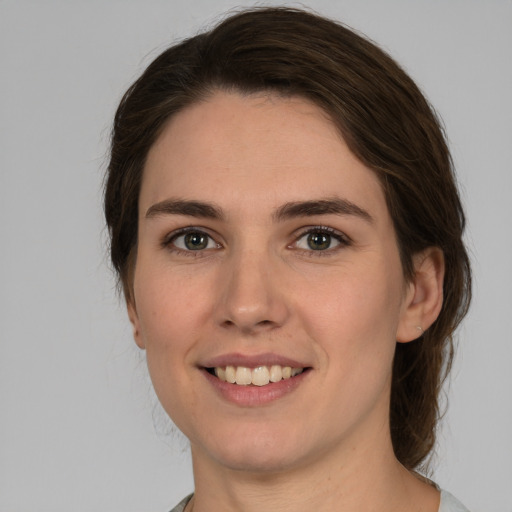 Joyful white young-adult female with medium  brown hair and brown eyes