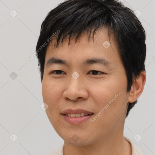 Joyful asian young-adult male with short  brown hair and brown eyes