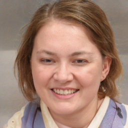 Joyful white young-adult female with medium  brown hair and blue eyes