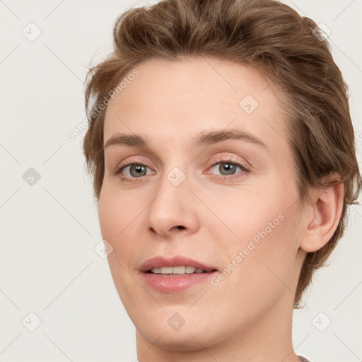 Joyful white young-adult female with short  brown hair and grey eyes