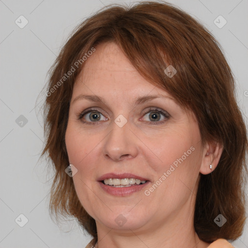 Joyful white adult female with medium  brown hair and grey eyes