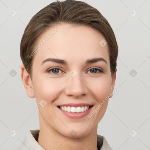 Joyful white young-adult female with short  brown hair and grey eyes