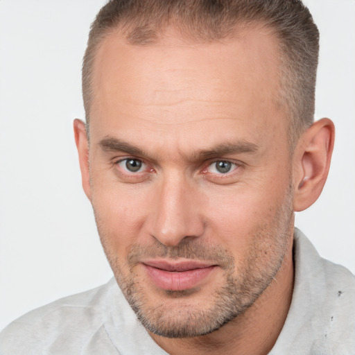 Joyful white adult male with short  brown hair and brown eyes