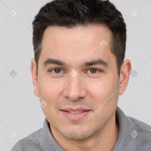 Joyful white adult male with short  brown hair and brown eyes