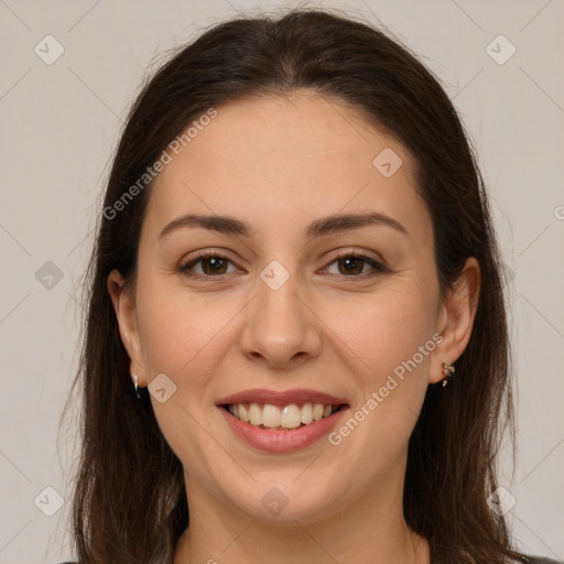 Joyful white young-adult female with long  brown hair and brown eyes