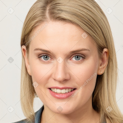 Joyful white young-adult female with long  brown hair and blue eyes