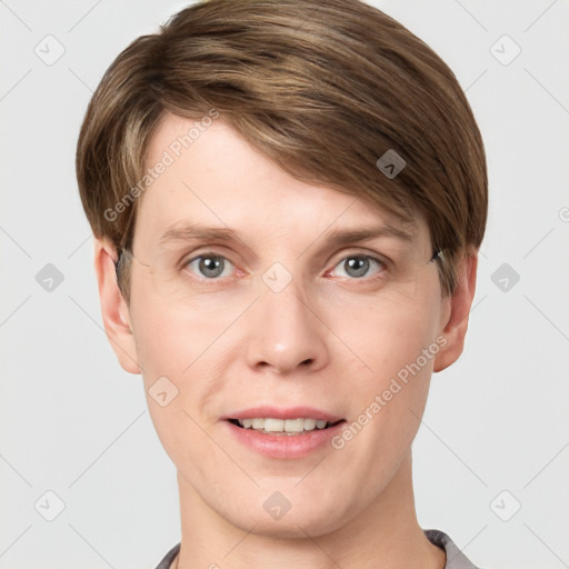 Joyful white young-adult male with short  brown hair and grey eyes