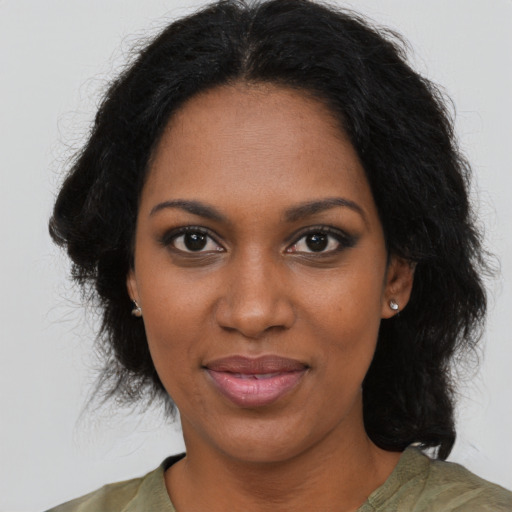 Joyful black young-adult female with medium  brown hair and brown eyes