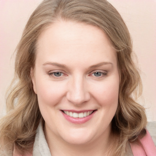 Joyful white young-adult female with long  brown hair and blue eyes