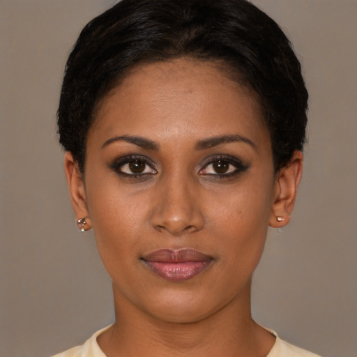 Joyful black young-adult female with short  brown hair and brown eyes