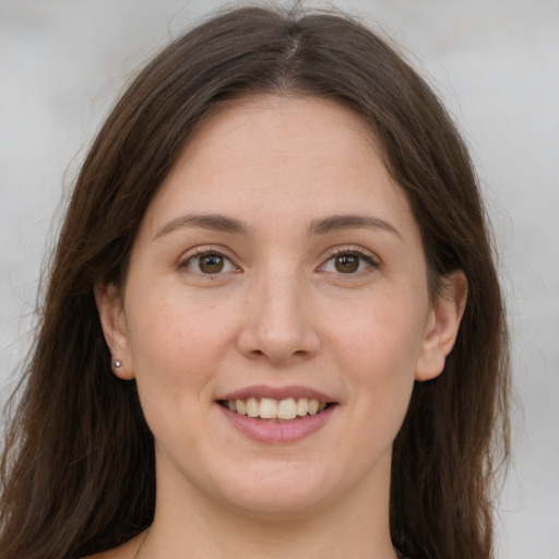 Joyful white young-adult female with long  brown hair and grey eyes