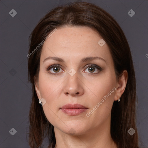 Joyful white adult female with long  brown hair and brown eyes