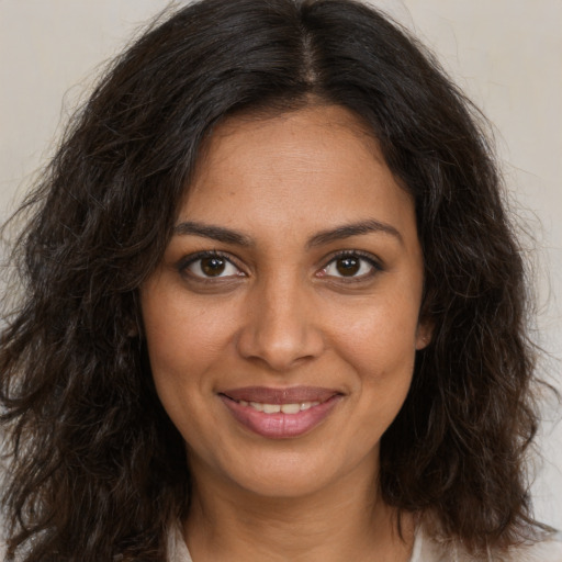 Joyful black young-adult female with medium  brown hair and brown eyes