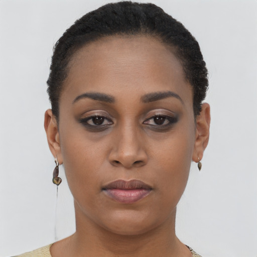 Joyful black young-adult female with short  brown hair and brown eyes