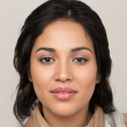 Joyful latino young-adult female with medium  brown hair and brown eyes