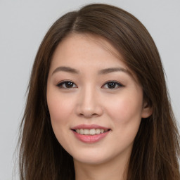 Joyful asian young-adult female with long  brown hair and brown eyes