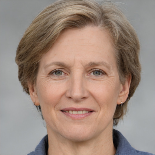 Joyful white adult female with medium  brown hair and grey eyes