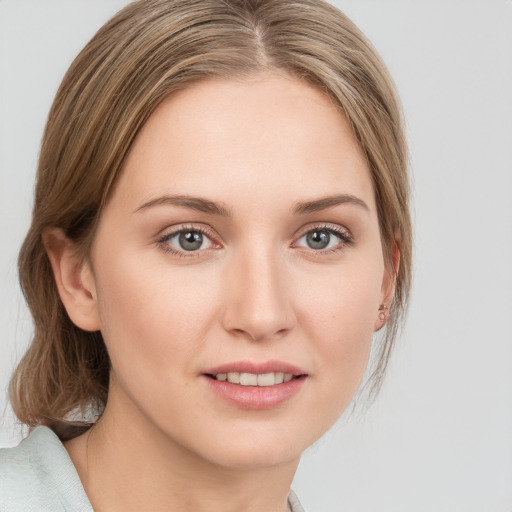 Joyful white young-adult female with medium  brown hair and blue eyes