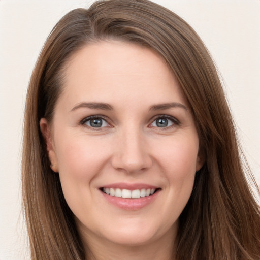 Joyful white young-adult female with long  brown hair and brown eyes