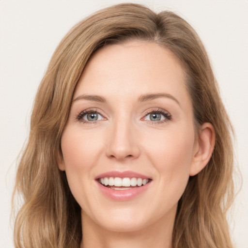 Joyful white young-adult female with long  brown hair and green eyes