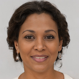 Joyful white adult female with medium  brown hair and brown eyes