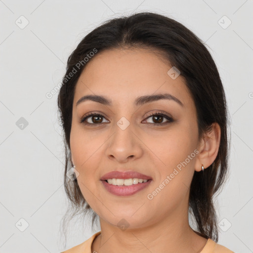 Joyful latino young-adult female with medium  brown hair and brown eyes