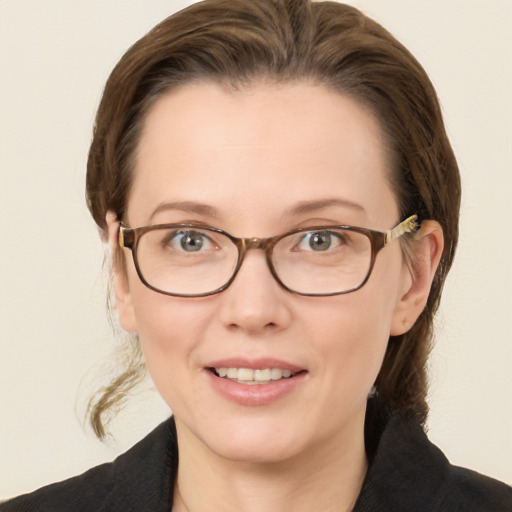 Joyful white young-adult female with medium  brown hair and blue eyes