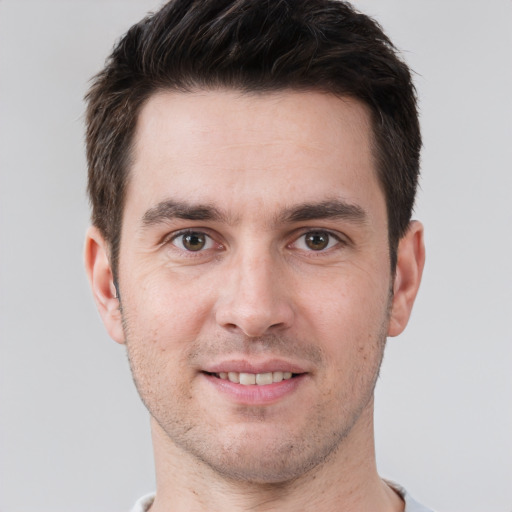 Joyful white young-adult male with short  brown hair and brown eyes