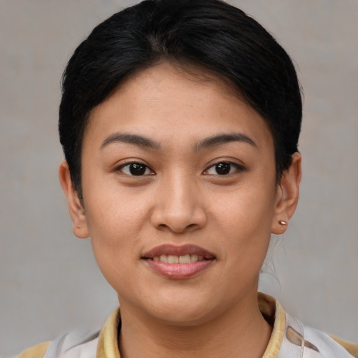 Joyful asian young-adult female with short  brown hair and brown eyes